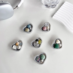 Detail of silver phone grip set with pearls, gems and floral resin charms in luxury style