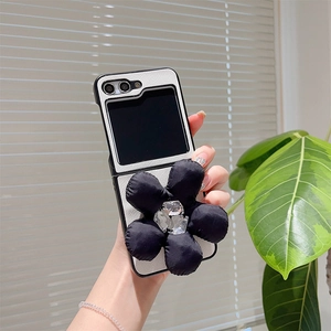 Detail of silver woven leather phone case with large black knit flower for Samsung Z Flip6