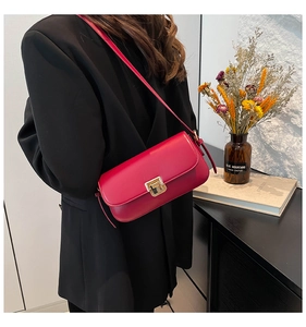 Detail der roten Vintage-Schultertasche mit goldenem Verschluss und Lederriemen