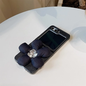 Detail of luxury leather Z Flip 6 case with 3D rhinestone flower and cross pattern texture