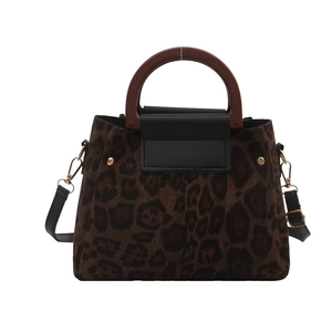 Retro leopard print tote bag with dark round wooden handles and gold metal hardware