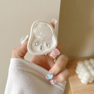 Detailed view of cloud-shaped phone grip with pearl finish and crystal water droplets