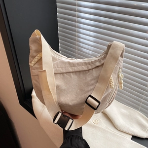 Beige corduroy crescent crossbody bag with adjustable wide strap for casual daily use