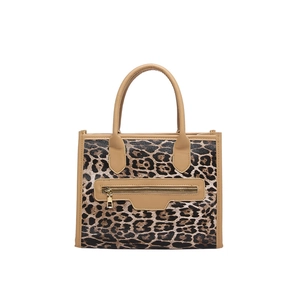 Large leopard print tote bag with brown circular handles and front zip pocket