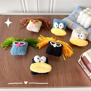 Plush funny big mouth doll phone grip stand with sunglasses on wooden tabletop