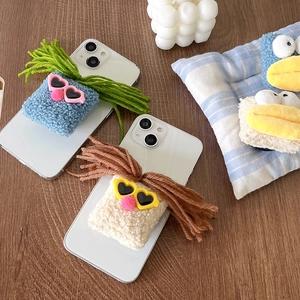 Funny plush phone grip with big mouth and heart sunglasses on a smartphone back