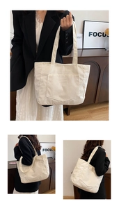 Detailed texture of beige corduroy tote bag featuring front pocket and woven shoulder strap