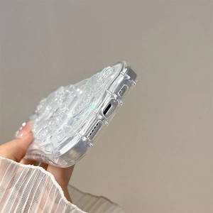 Macro view of clear iPhone case featuring 3D butterfly design and precise charging port cutout