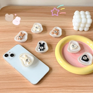 Cute bear and rabbit expandable phone grip tok with rhinestone heart on light wood desk