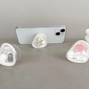Detail of floral and heart-shaped pearl phone grip stands with resin coating and 3D design