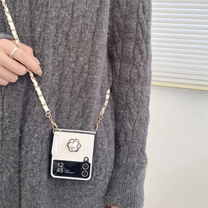 Detail of white leather folding phone case with camellia flower and pearl chain strap