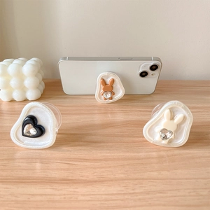 Sparkling rhinestone bear and heart phone grip set on a white mobile phone