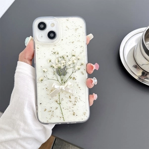 Detail of floral iPhone case with embedded real dried flowers and a white 3D bowknot