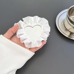 Handheld heart-shaped makeup mirror with elegant white lace ruffles and cloth edging