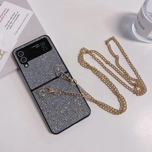 Close-up of glittery Samsung Galaxy Z Flip case with golden metal chain strap on white background