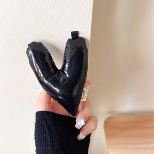 Macro view of 3D puffy black leather heart phone grip and stand with ribbon loop