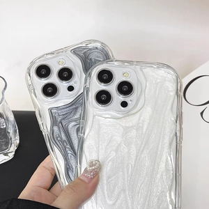 Close-up of wavy texture phone case set in black and white pearlescent fluid finish