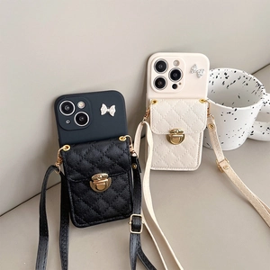 Crossbody iPhone case with bow lock wallet and adjustable leather strap in black and cream