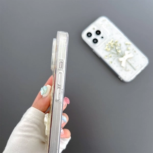 Detail of floral iPhone case showing precise side buttons and 3D bow design