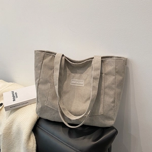 Vintage corduroy tote bag in oat grey featuring dual straps and front brand patch