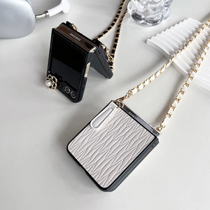 Detailed view of luxury camellia pearl phone cases with golden crossbody chains
