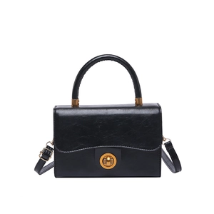 Classic black vintage crossbody bag with polished leather finish and bronze metal lock