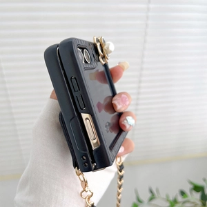 Detail of Z Flip 5 case with camellia pearl decor and crossbody leather chain strap