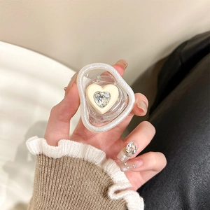 Close-up of cream heart phone grip with sparkling rhinestone and resin glitters
