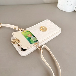 Detail of white quilted phone case with gold twist-lock wallet and crossbody leather strap