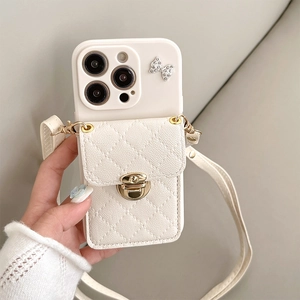Detail of cream iPhone case with quilted wallet, gold clasp, and long crossbody strap
