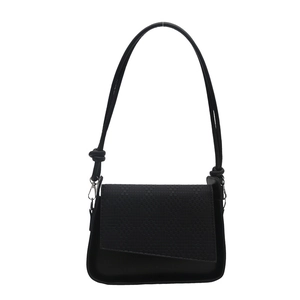 Black woven textured shoulder bag with asymmetric flap design and knotted strap detail