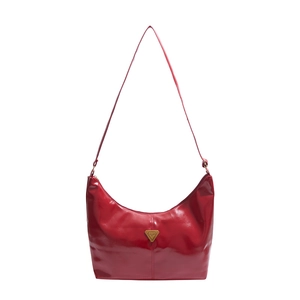 Classic red patent leather hobo bag with gold triangle logo and minimalist shoulder strap