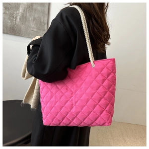 Hot pink quilted tote bag with diamond stitching and white braided rope shoulder straps