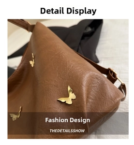 Macro shot of brown pebble leather texture and gold butterfly metal accents on handbag