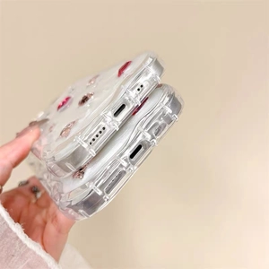 Detail of clear iPhone case with pink and red gemstone inlay and precise speaker cutouts