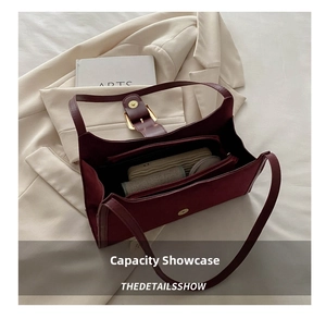 Interior view of burgundy suede handbag showing spacious compartments for daily items