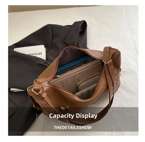 Detailed top view of brown leather bag interior showing large capacity and zipper pocket