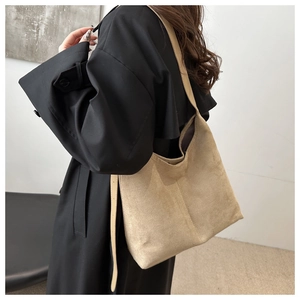Detail of large suede tote bag in khaki showing soft texture and spacious commuting design