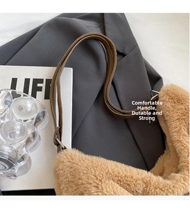 Detail of plush winter tote bag showing brown faux fur texture and leather strap attachment