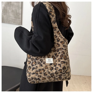 Detail of plush leopard print tote bag showing soft texture and shoulder carry style