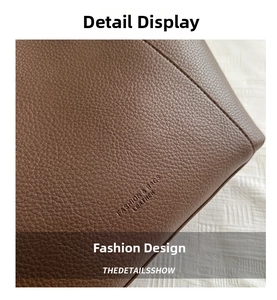 Detailed macro view of brown lychee grain leather texture with embossed fashion logo
