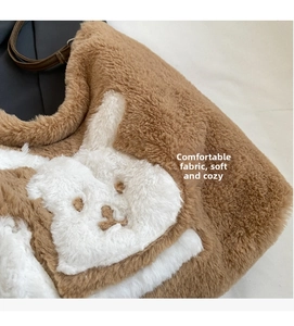 Detailed view of plush tote bag fabric with cute white rabbit pattern and brown straps