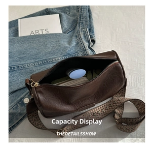 Detail view of the deep brown vintage barrel bag interior showing compact storage capacity