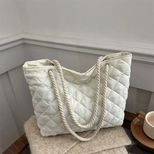 White quilted tote bag with diamond stitching and cotton rope handles for winter