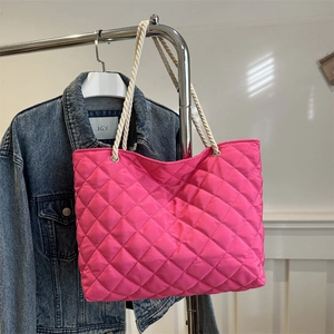 Fuchsia quilted tote bag with large capacity and rustic rope handles for daily commute