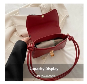 Interior view showing spacious capacity of a red leather baguette bag with metal clasp