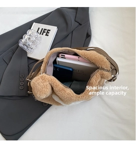 Macro view showing spacious interior capacity of camel plush tote bag with daily items