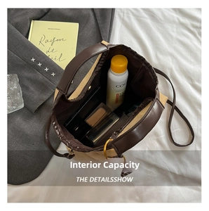 Interior view showing the large capacity of the brown leather and canvas tote bag