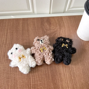 Three cute plush kitten phone socket stands with golden bows in white, brown and black