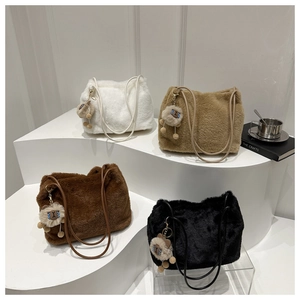 Detail of plush tote bags in four colors with long fur texture and cute doll pendants